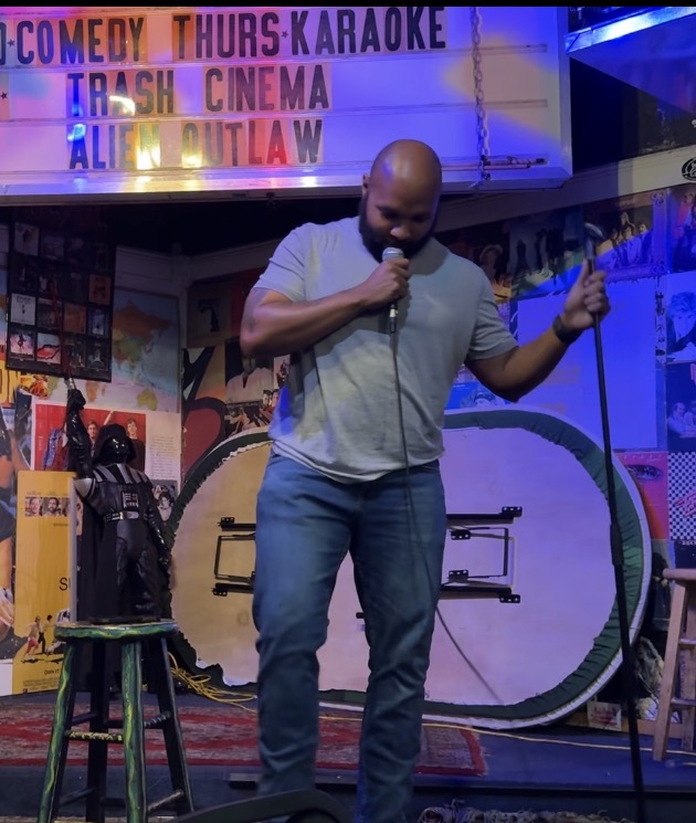 AJ Frazier performing stand-up comedy on stage